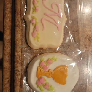 two decorated cookies on a counter