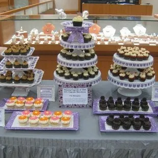 a display of cupcakes and pastries