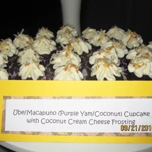 a plate of cupcakes with cream cheese frosting