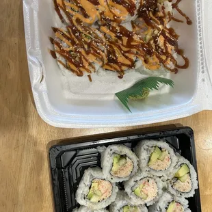 a plastic container of sushi rolls