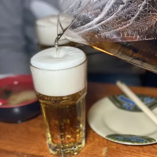 a beer being poured into a glass