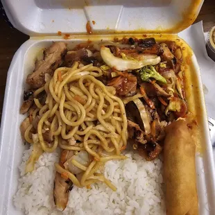 Hot spicy chicken teriyaki and a side of noodles with a spring roll