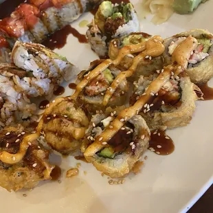 a plate of sushi and rolls
