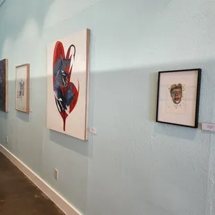 a hallway with paintings on the wall