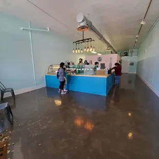 a couple of people standing in front of a counter