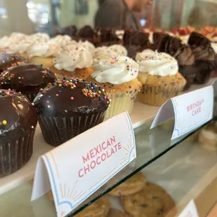 a variety of cupcakes on display