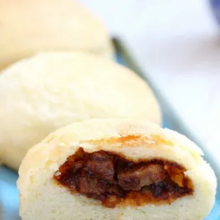 a close up of a bun with a bite taken out of it