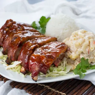 a plate of ribs and coleslaw