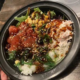 a hand holding a bowl of food