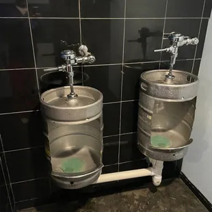 two stainless steel urinals