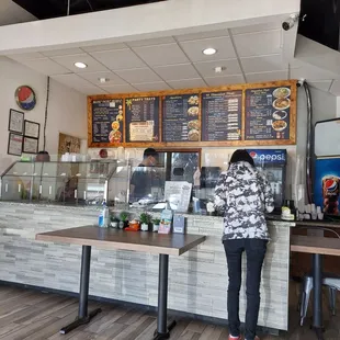 a woman standing in front of the counter