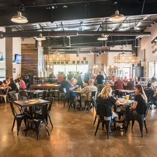 people sitting at tables in a restaurant
