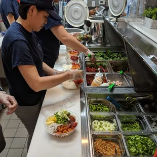 a group of people preparing food