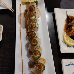 a plate of sushi with chopsticks