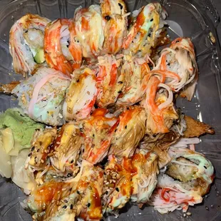 a plastic container filled with sushi rolls