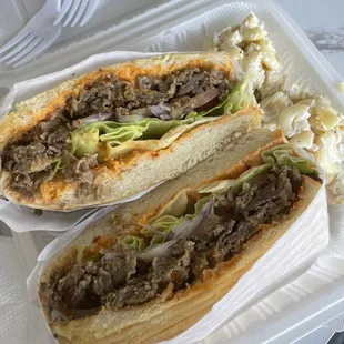 two sandwiches in a styrofoam container
