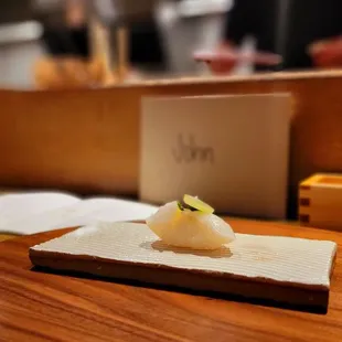 a sushi dish on a wooden plate