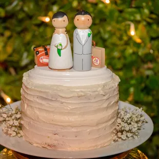 a wedding cake with a bride and groom on top