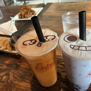 two drinks with faces drawn on them