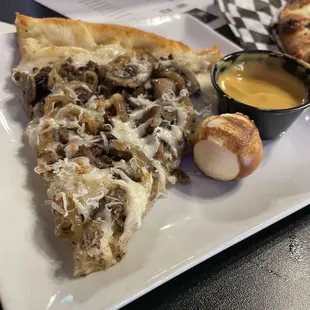 this is the steakhouse Pizza along with their pretzel bites and an amazing cheese dip. They also have a honey mustard dip.