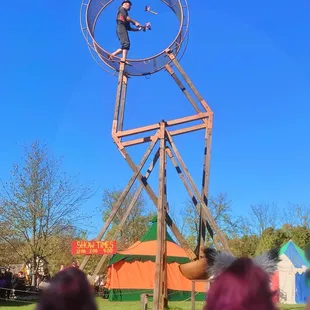 Juggling flamed axes on Wheel of Death