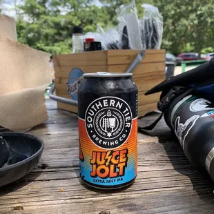 a can of beer on a picnic table