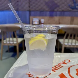 a glass of water with a lemon wedge