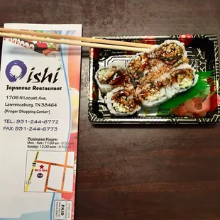 a plate of sushi and chopsticks