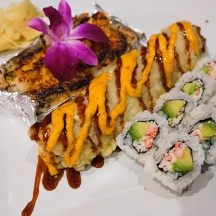 a plate of sushi and rolls