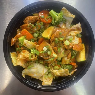 Spicy Chicken Bowl, chicken marinated with a special spicy sauce mixed with vegetables served over rice and a sprinkle of green onions