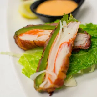 Deep fried jalapeños, stuffed with crab, jalapeño wrapped in bacon served with a side of special sauce