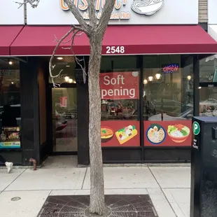 a tree in front of the store