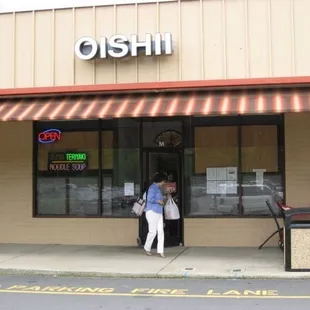 a man standing in front of a restaurant