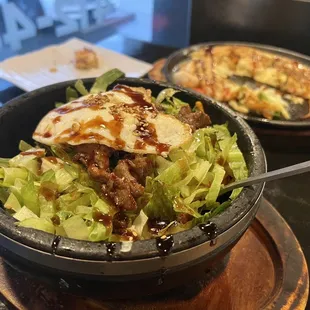 a bowl of salad and a plate of pizza