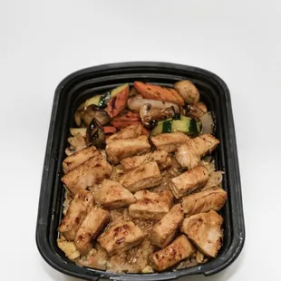 a chicken dish in a black container