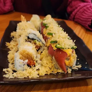 a person sitting at a table with a plate of food