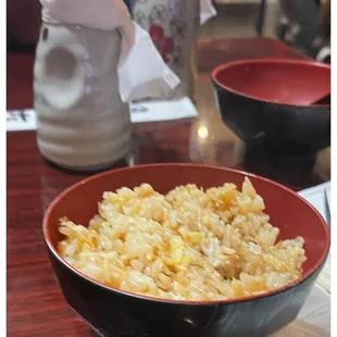 a bowl of rice and two bowls of rice on a table