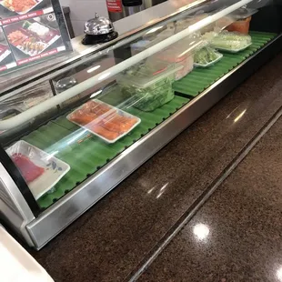 a deli counter with a variety of food items