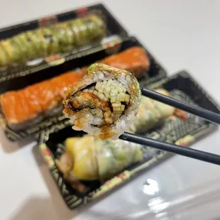 a sushi roll and chopsticks