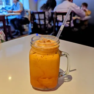 a jar of orange juice on a table