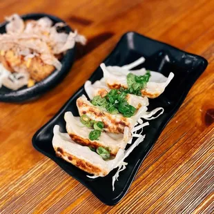 a plate of ramen and a plate of chicken