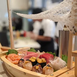  a wooden boat filled with sushi