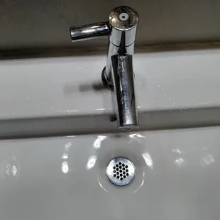 Great bathroom fixtures but too close to the edge to wash hands without touching the bowl