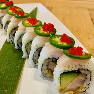 a row of sushi rolls on a white plate