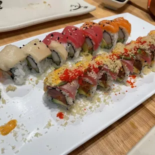 a variety of sushi on a white plate
