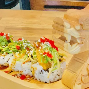a wooden dragon on a wooden plate
