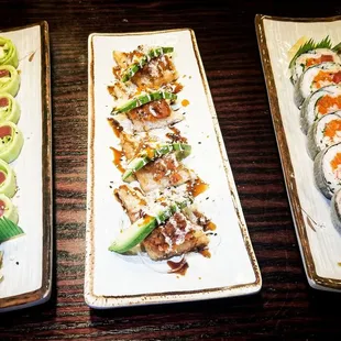 three plates of sushi on a table