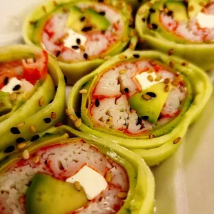 a close up of a plate of sushi rolls