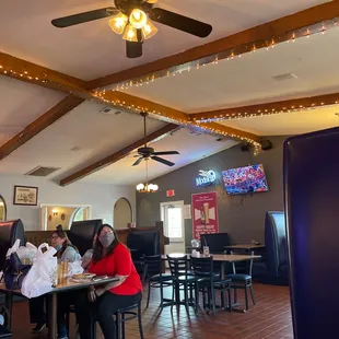 people sitting at tables in a restaurant