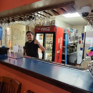 Happy bartender makes good drinks